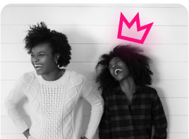 Two women, one with a crown smiling hard